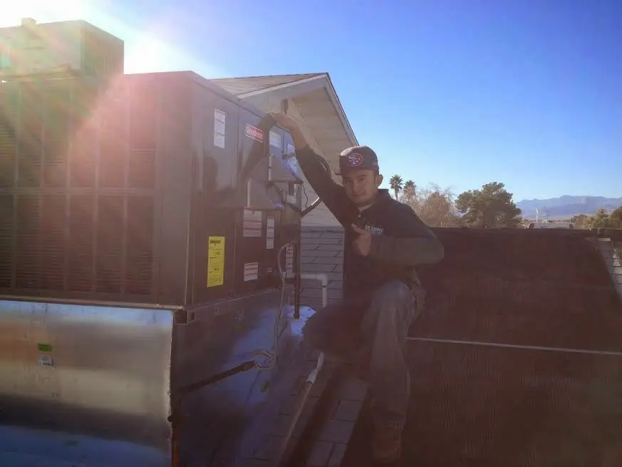 HVAC technician performing Heat Pump Repair on a rooftop unit in West Covina